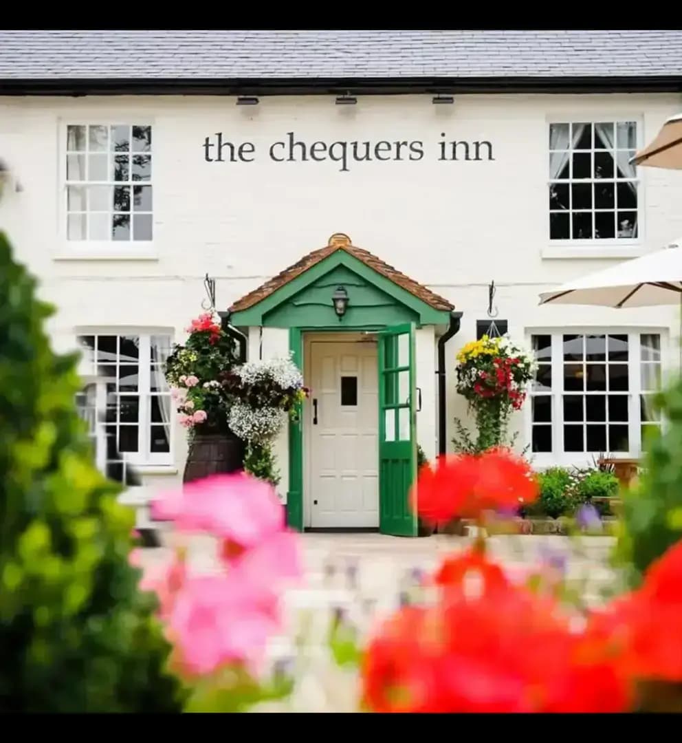 Exterior shot of the Chequers Inn gastro-pub, taken from the quaint outdoor seating area.