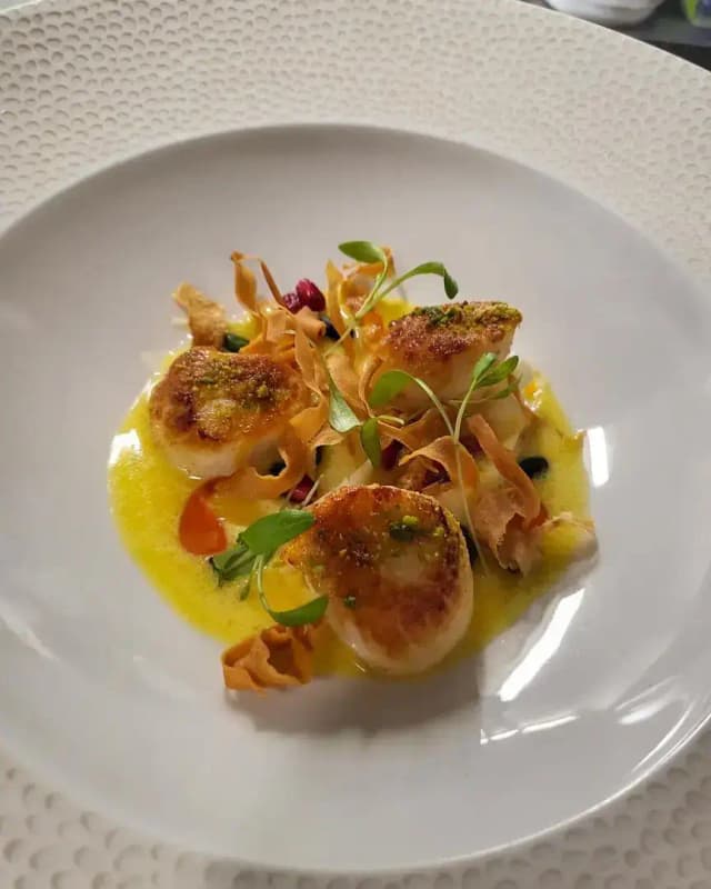 Scottish king scallops, saffron beurre blanc, pistachio, pickled parsnip